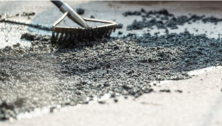 Asphalt resurfacing in Akron, OH is realized with a small rake.